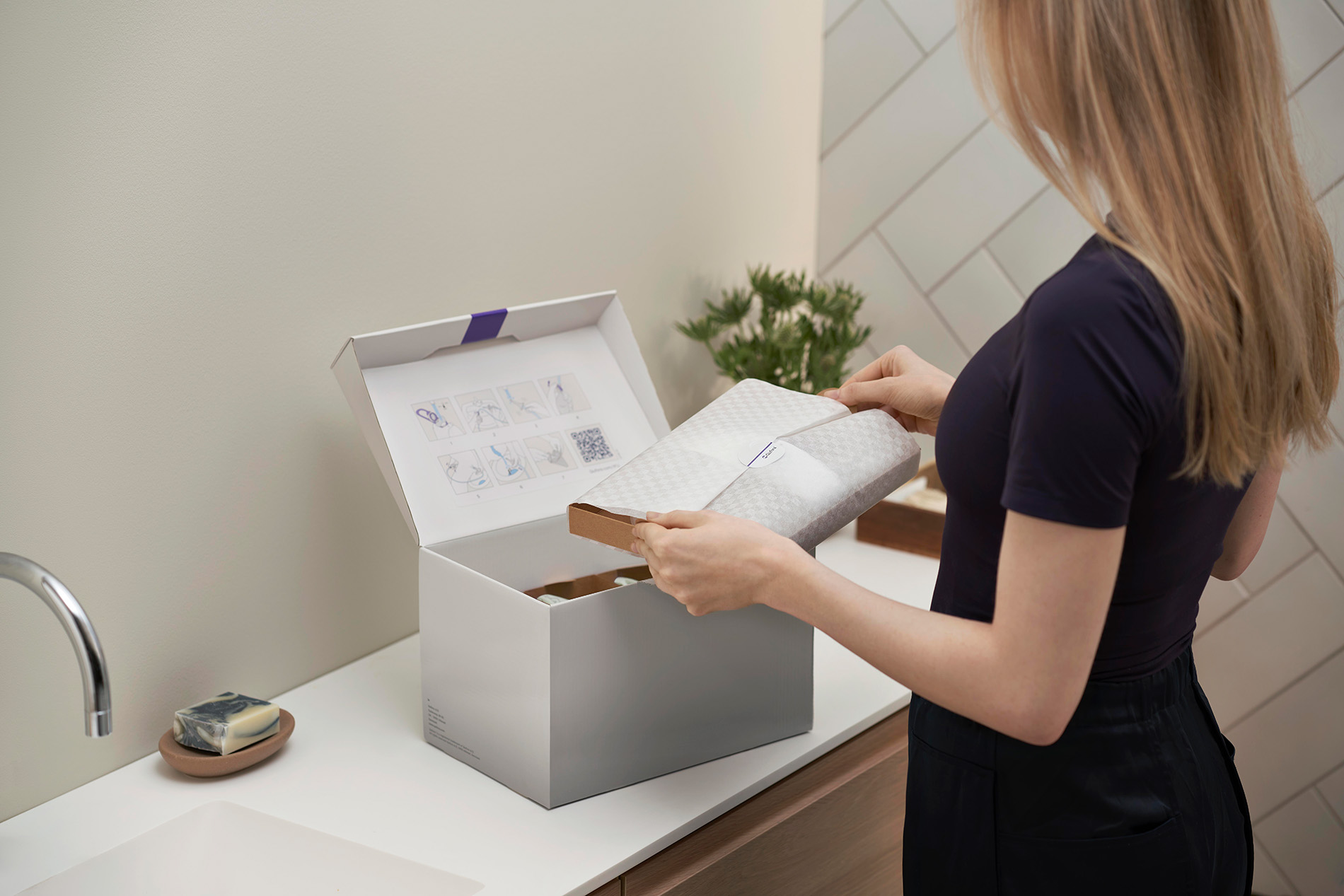 Woman opening a package with Qufora Flow