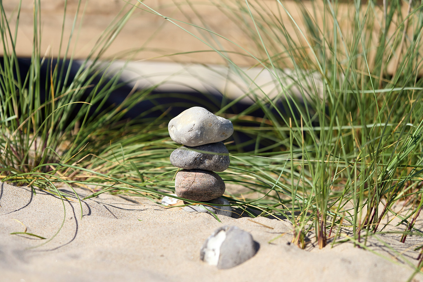 Qufora image of a stack of four small stones at the beach