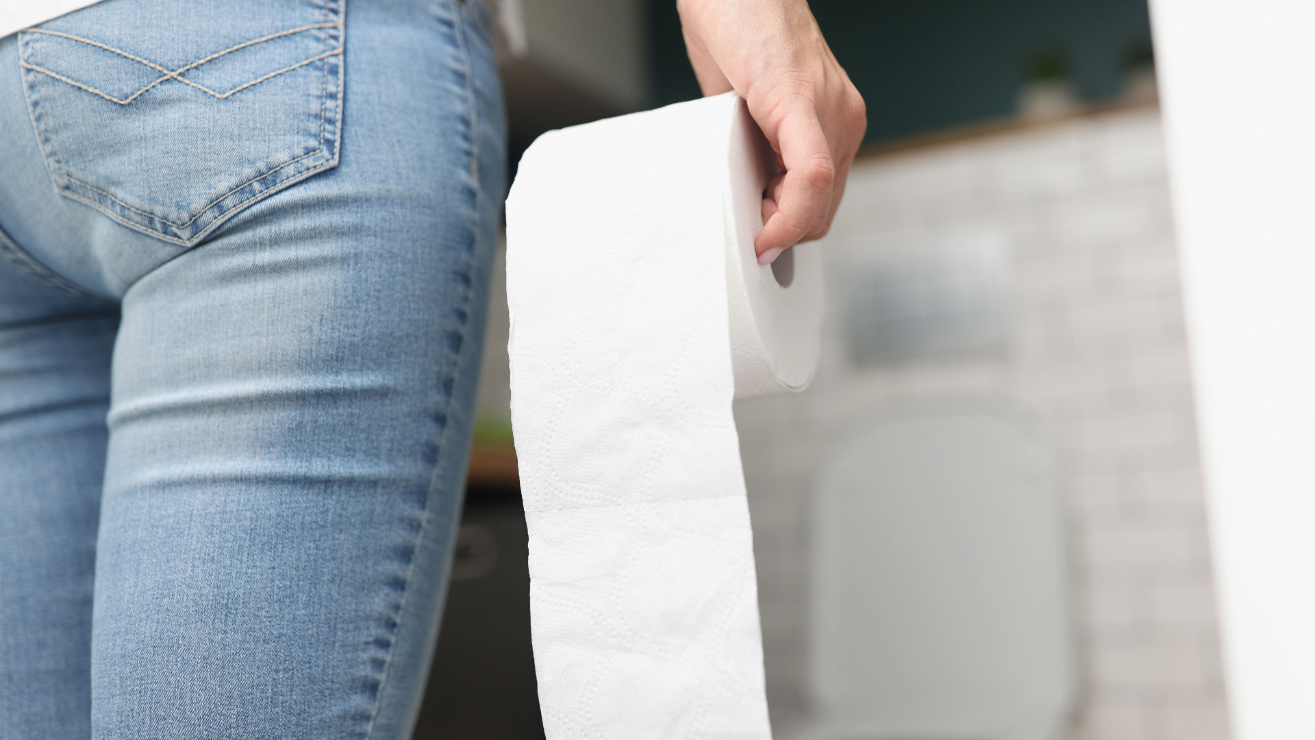 Hand holding toilet paper