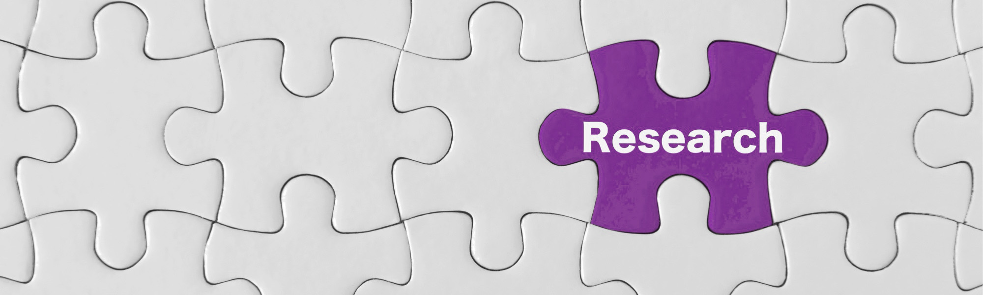 Image of puzzle pieces with the word "research"
