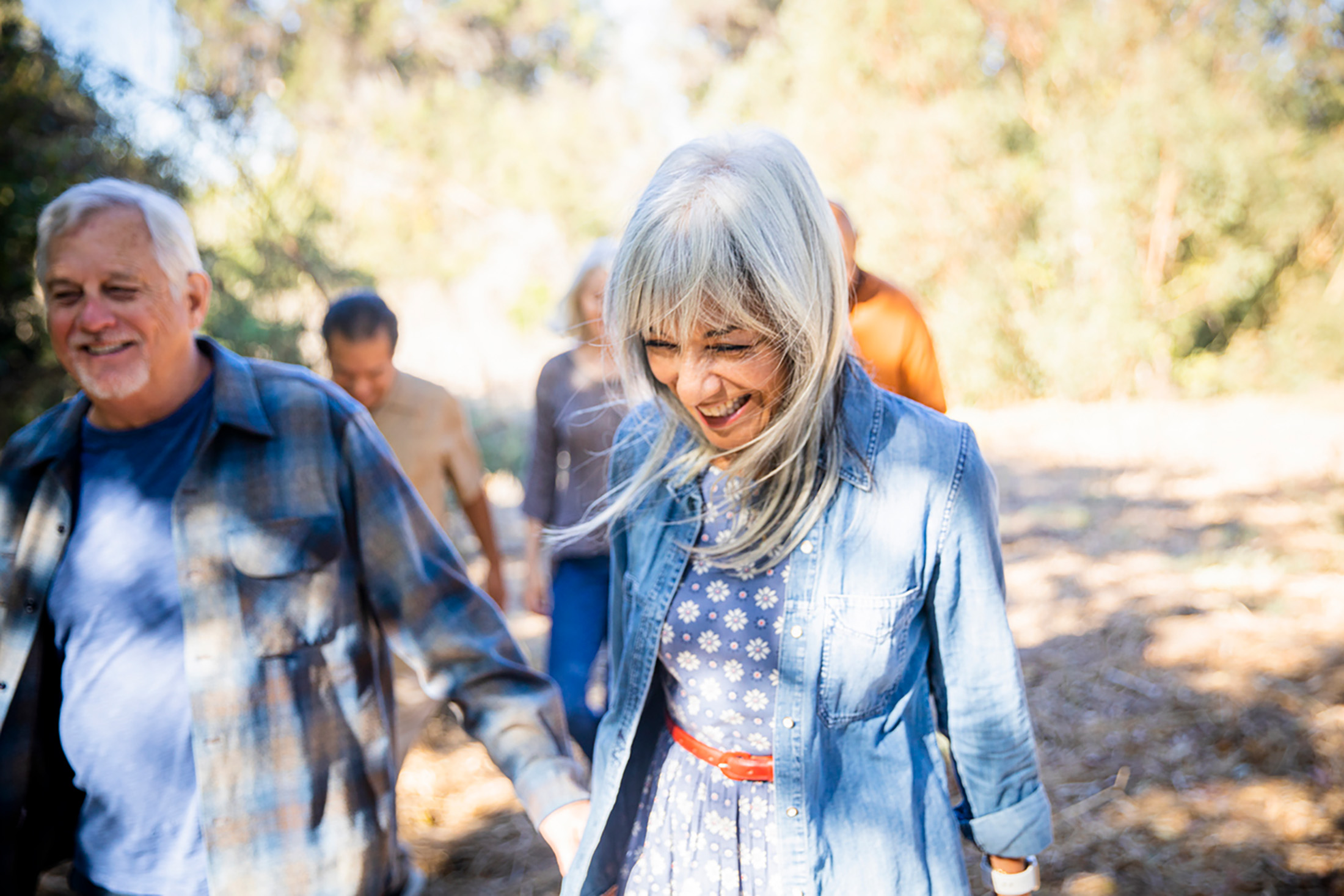 Seniors enjoying a relaxed walk in the forest