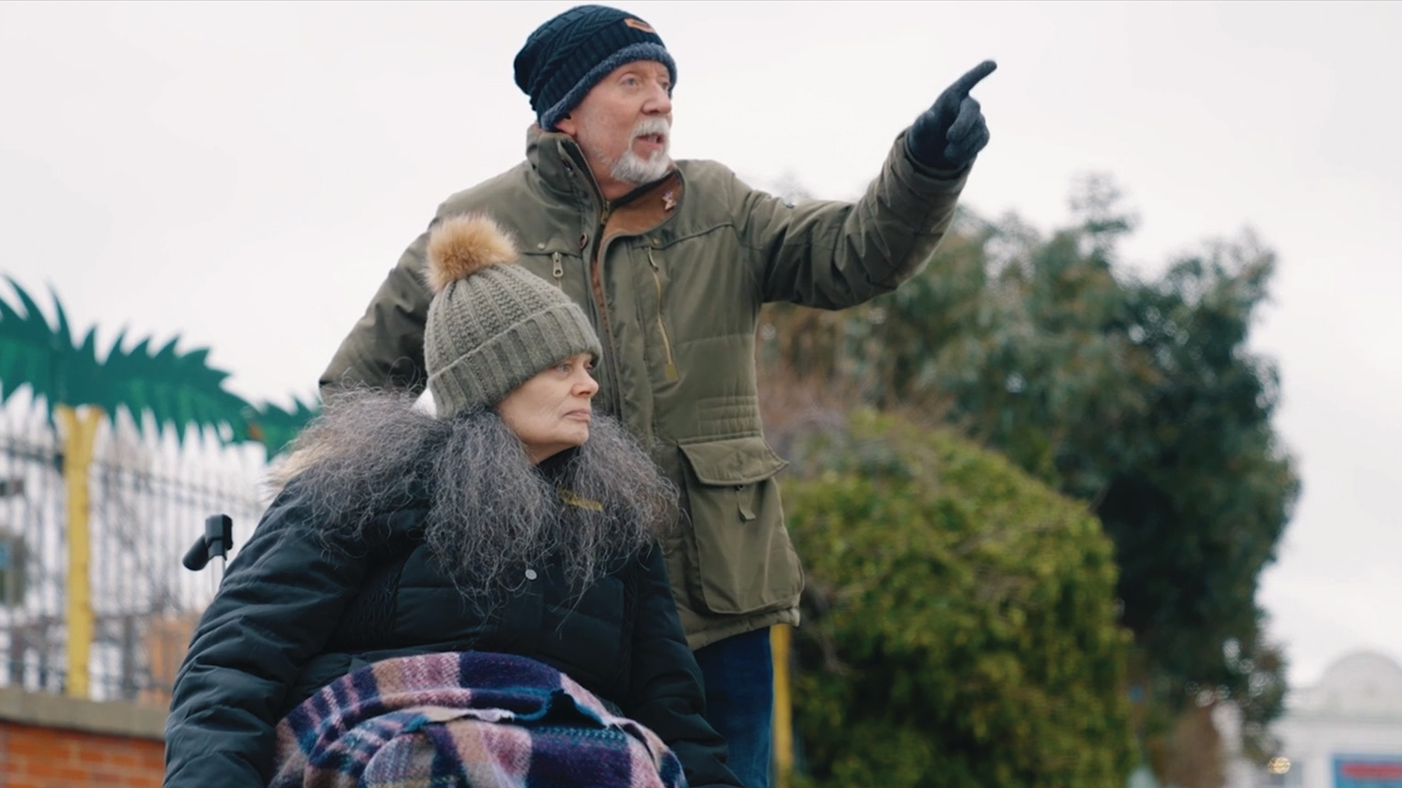 Kim and Steve outside, looking at something, Steve is pointing at