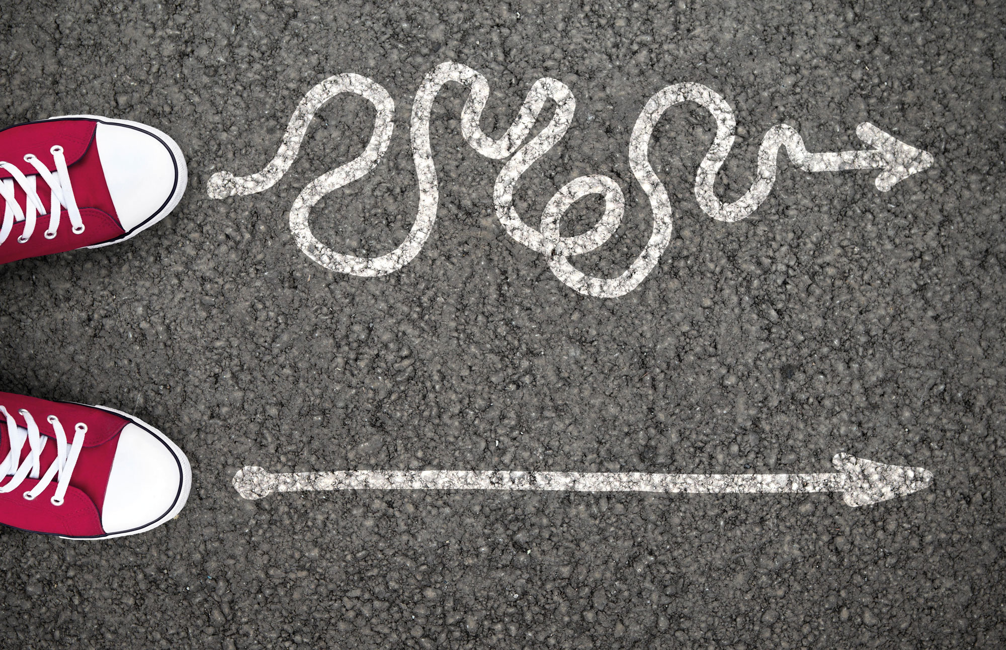 A curled and a straight arrow, drawed on the asphalt