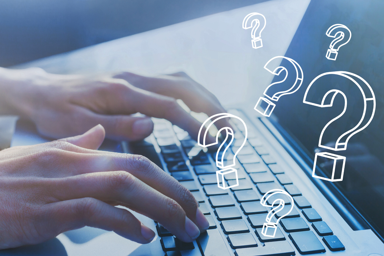 Hands writing on a laptops keyboard